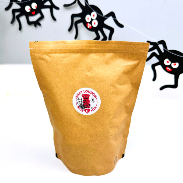 Bag of pick & mix sweets with fake spiders in the background